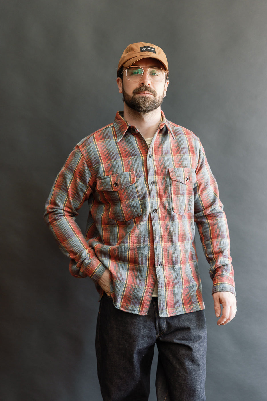 Adult male model wears the Lot 3022 Flannel Shirt w/ Chinstrap G Pattern - Red, Navy, showcasing its vintage-inspired plaid design, button-flap chest pockets, and authentic heritage detailing.