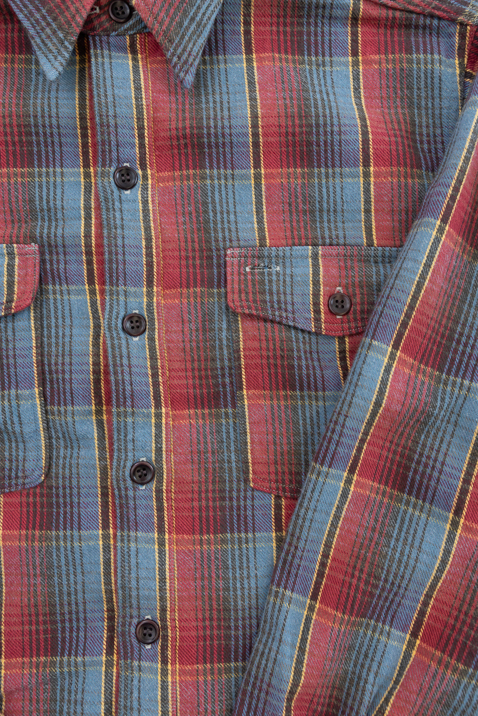 Close-up of the Lot 3022 Flannel Shirt w/ Chinstrap G Pattern, showcasing its red, blue, and yellow tartan plaid, brushed texture, collar, button placket, and flap chest pocket with button detail.