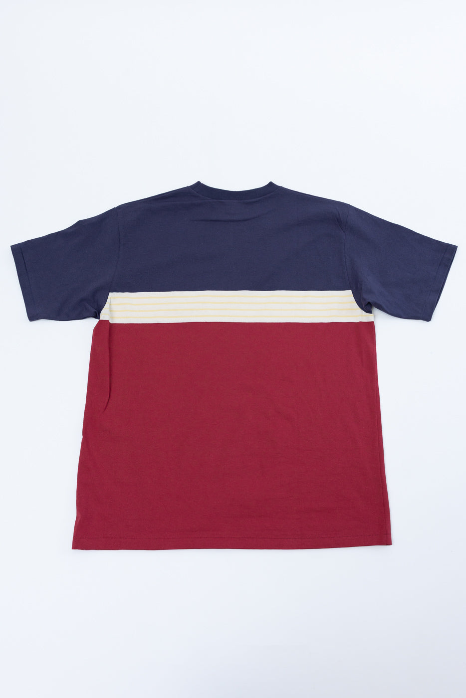 Front view flat lay of a colorblock t-shirt with navy, cream, and maroon stripes.
