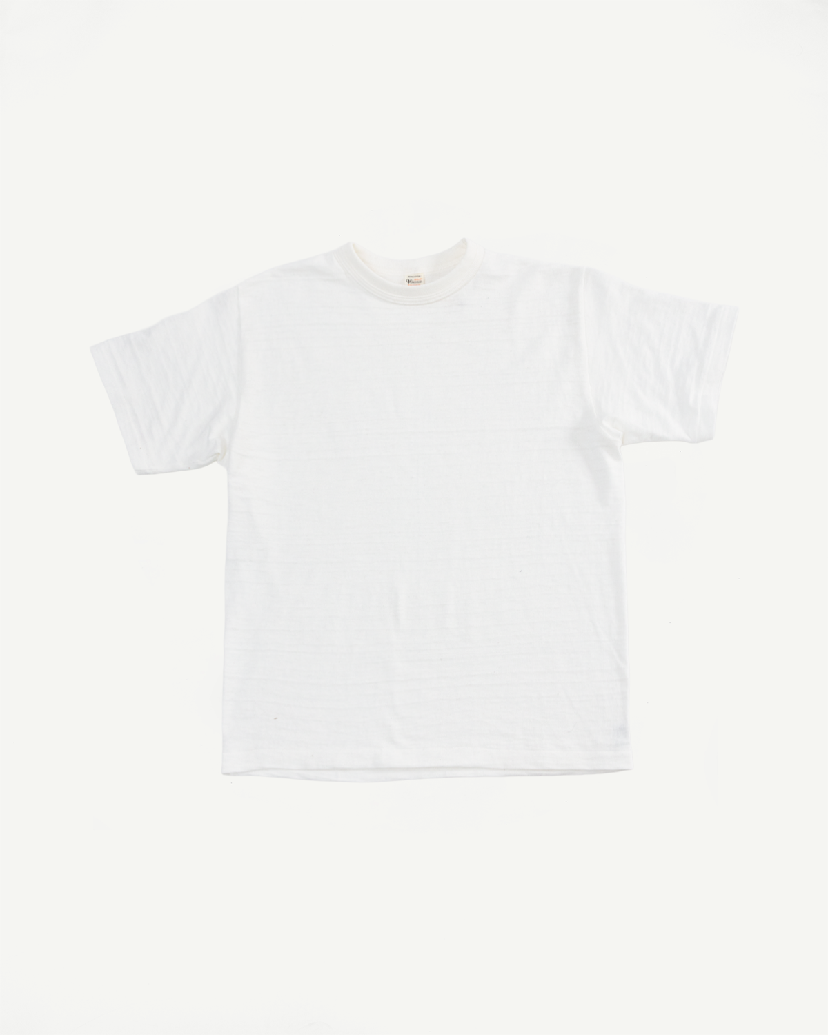 Flat lay front view of off-white slubby cotton T-shirt, short sleeves, crew neck detail.