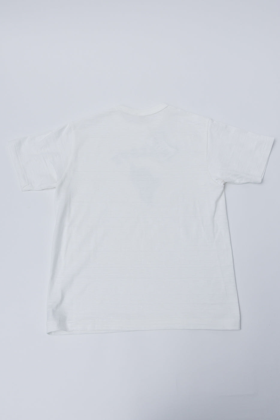 Flat lay of Warehouse & Co slubby cotton t-shirt in off-white, showing back side.