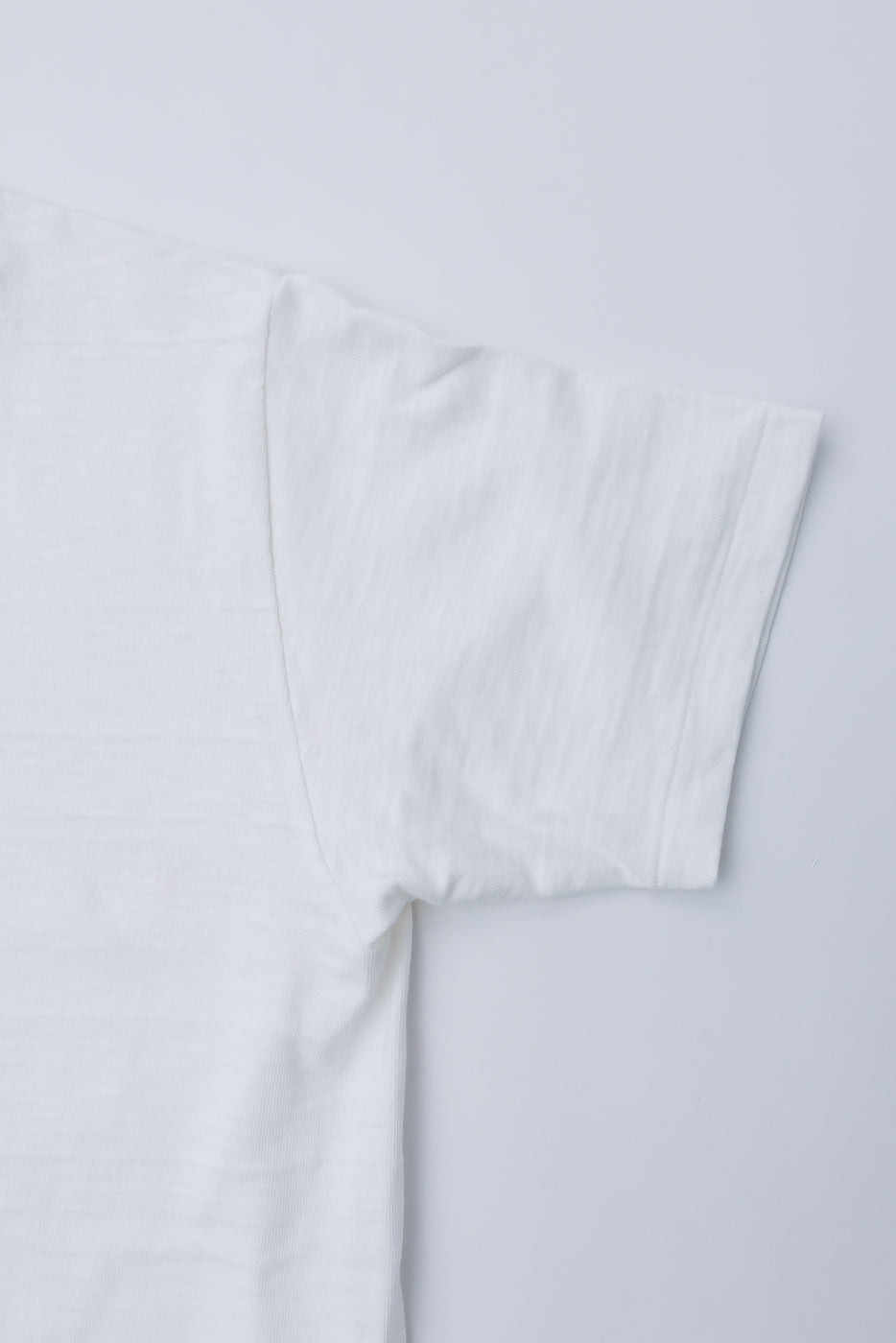 Close-up of right sleeve and shoulder, front side, off-white slubby cotton t-shirt, Dant