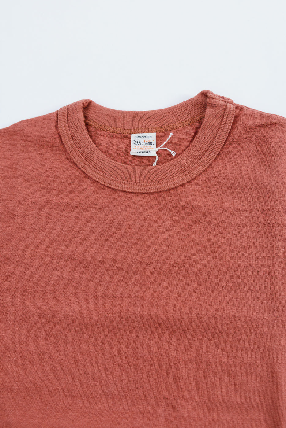 Lot 4601 - Slubby Cotton T-Shirt - Salmon: A rust-colored, crew-neck T-shirt with a textured finish, laid flat showcasing its seamless sides, ribbed collar, and vintage-inspired construction.