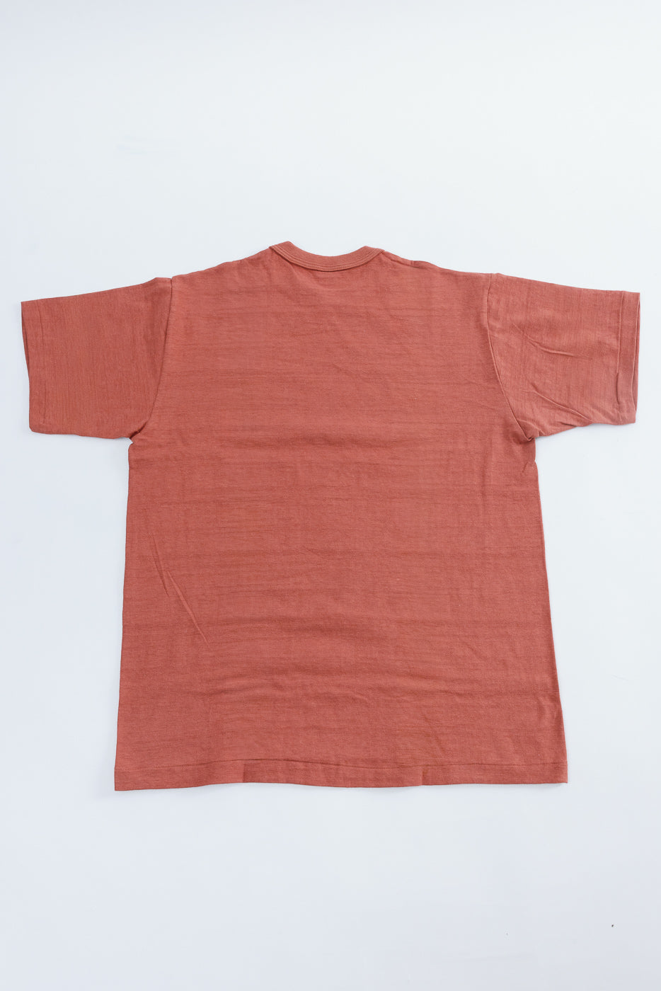 Lot 4601 - Slubby Cotton T-Shirt - Salmon in burnt-orange, showcasing its unique textured knit and ribbed collar, laid flat on a white background, highlighting the garment's artisanal craftsmanship.