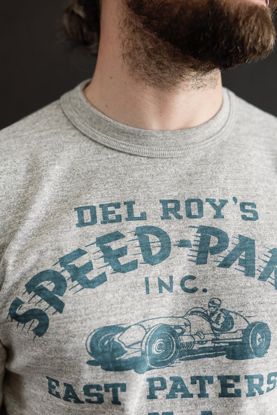 Close-up of front chest graphic on Warehouse & Co slubby cotton T-shirt, worn by male model 5'9