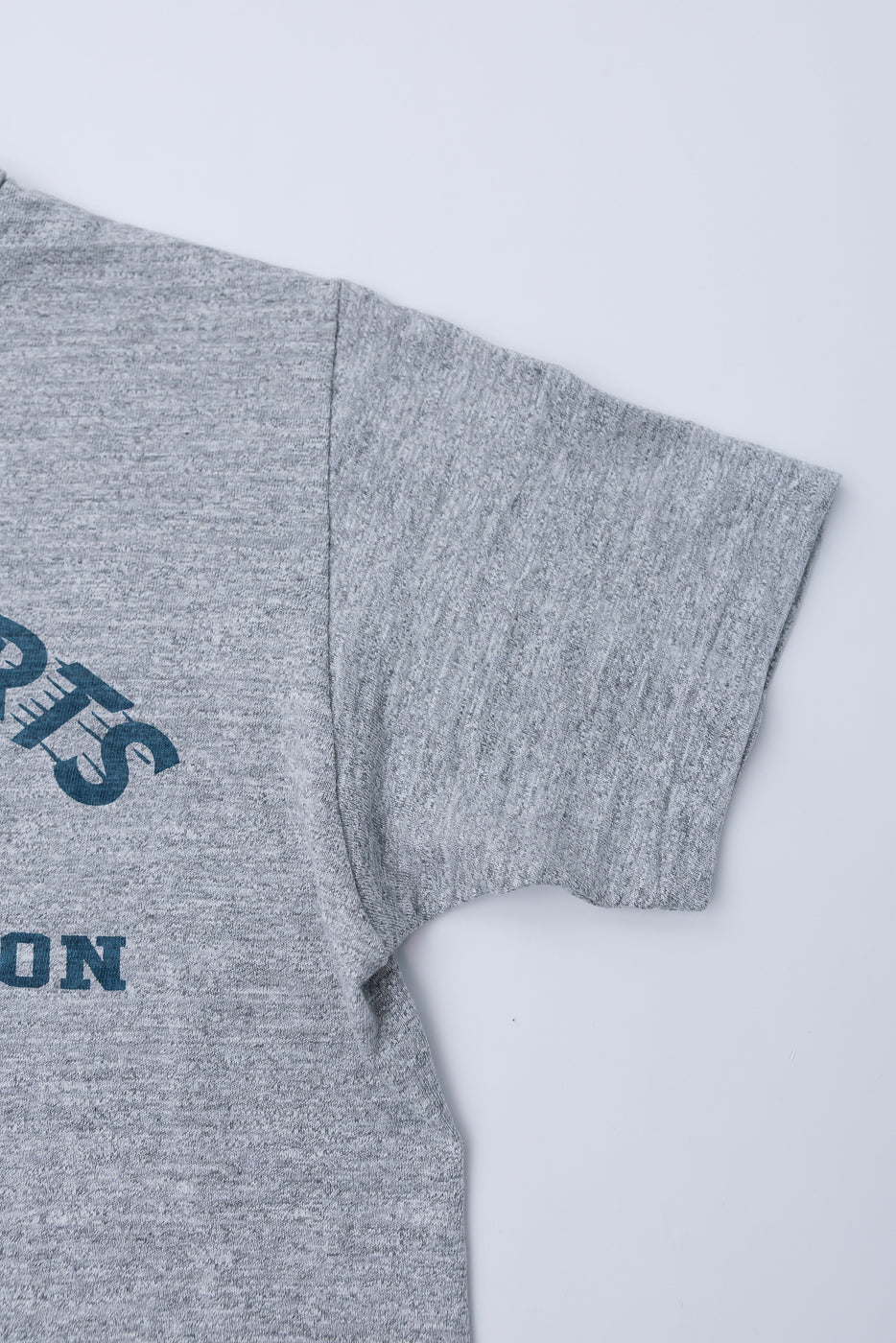 Close-up of Warehouse & Co. slubby cotton t-shirt right sleeve, front side, heather grey fabric