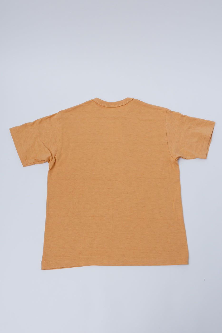 Flat lay of Warehouse & Co. slubby cotton t-shirt, orange, back side, short sleeves shown