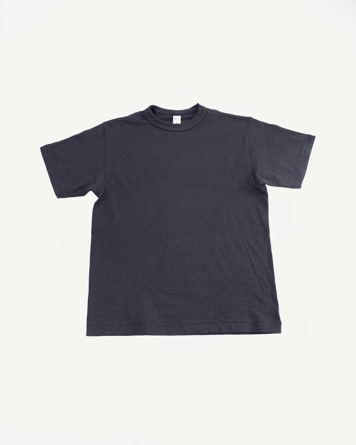 Flat lay of front of black slubby cotton t-shirt, showing crew neck and short sleeves.