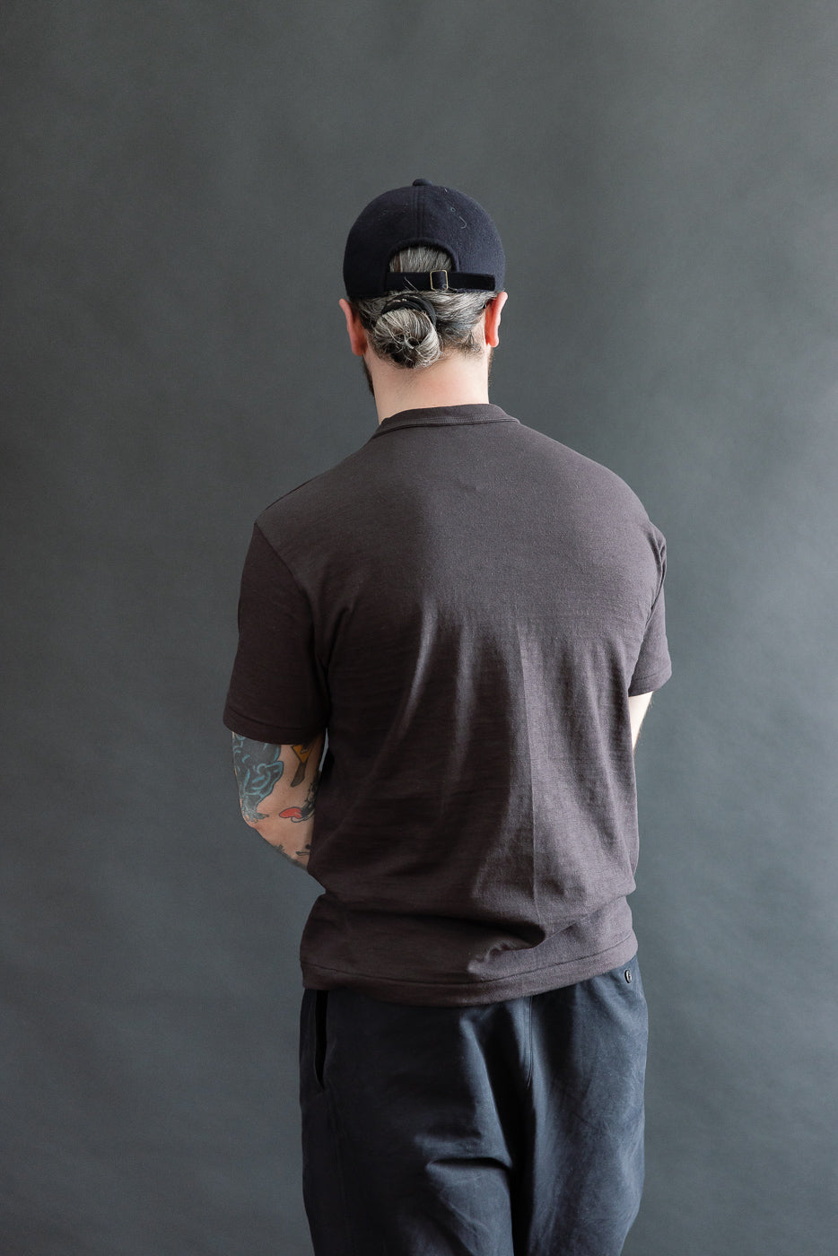 Male model 5'9 165lbs athletic build wearing slubby cotton t-shirt, back view, full body
