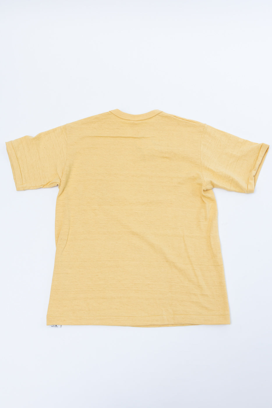 Flat lay of the back of a yellow short-sleeve t-shirt.