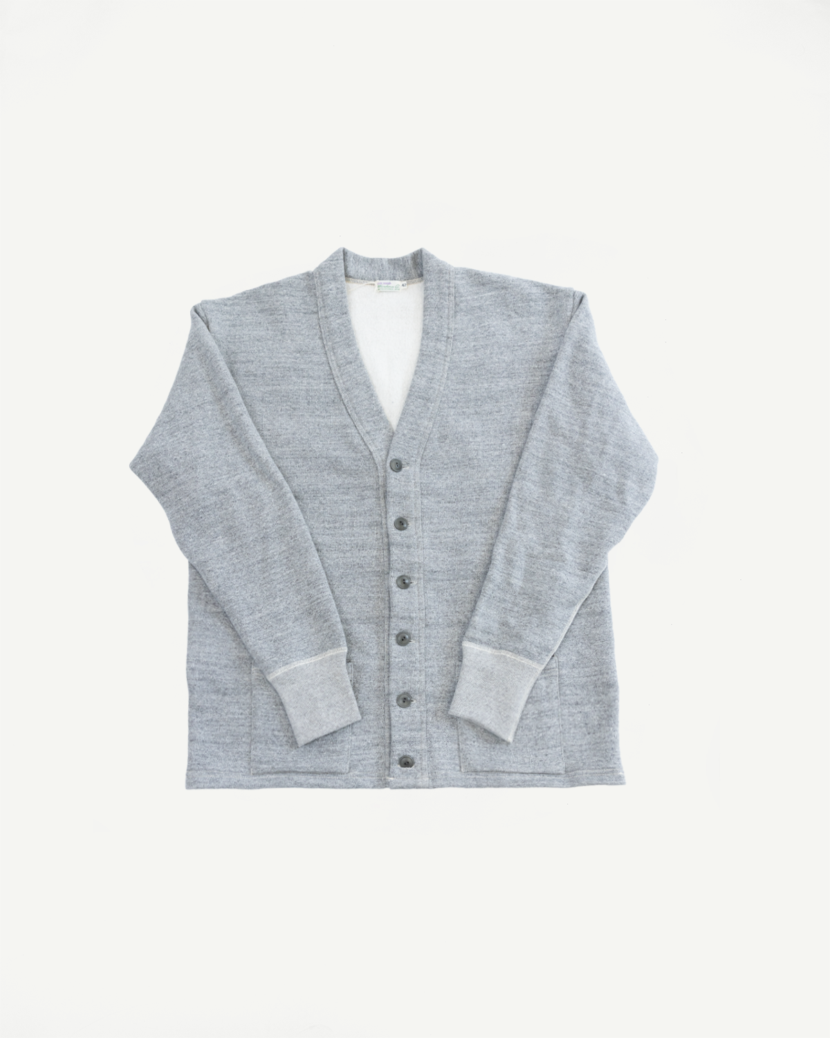 Flat lay, front view of heather grey cardigan, button-up, ribbed cuffs, textured fabric.