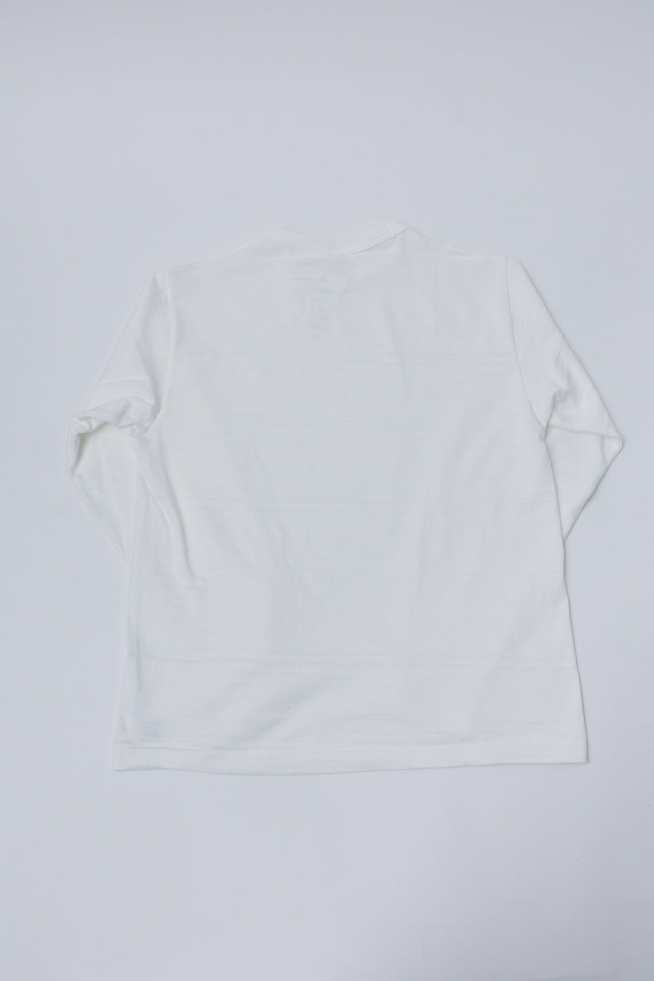 Flat lay of Warehouse & Co. off-white slubby cotton long sleeve t-shirt, back view