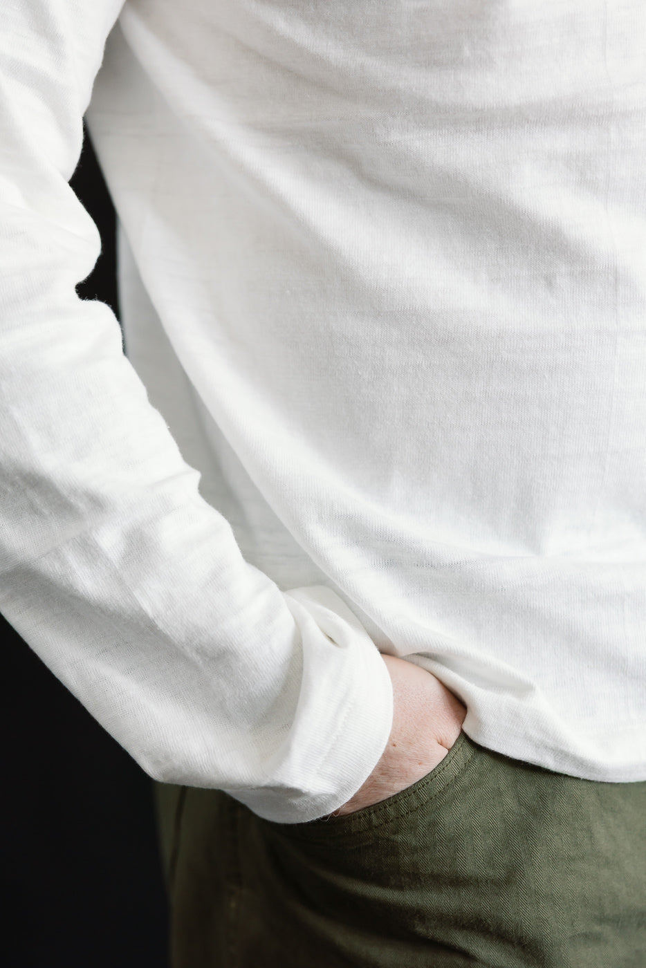 Close-up of slubby cotton long sleeve T-shirt in off-white, front side, on male model 5'9