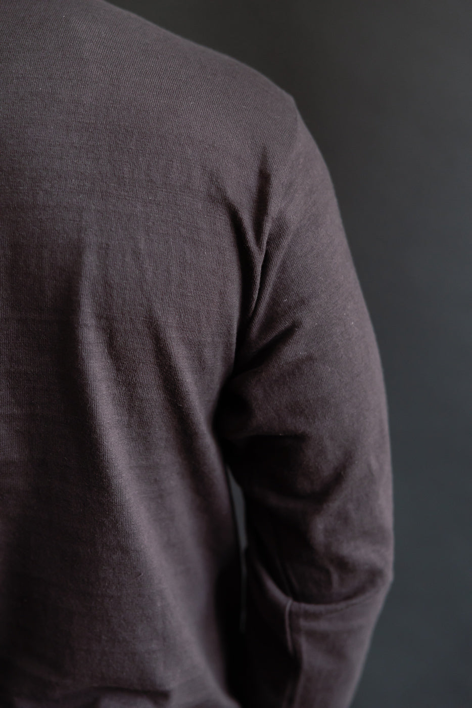 Close-up of Warehouse & Co slubby cotton long sleeve t-shirt, back shoulder fabric texture on male model, athletic build
