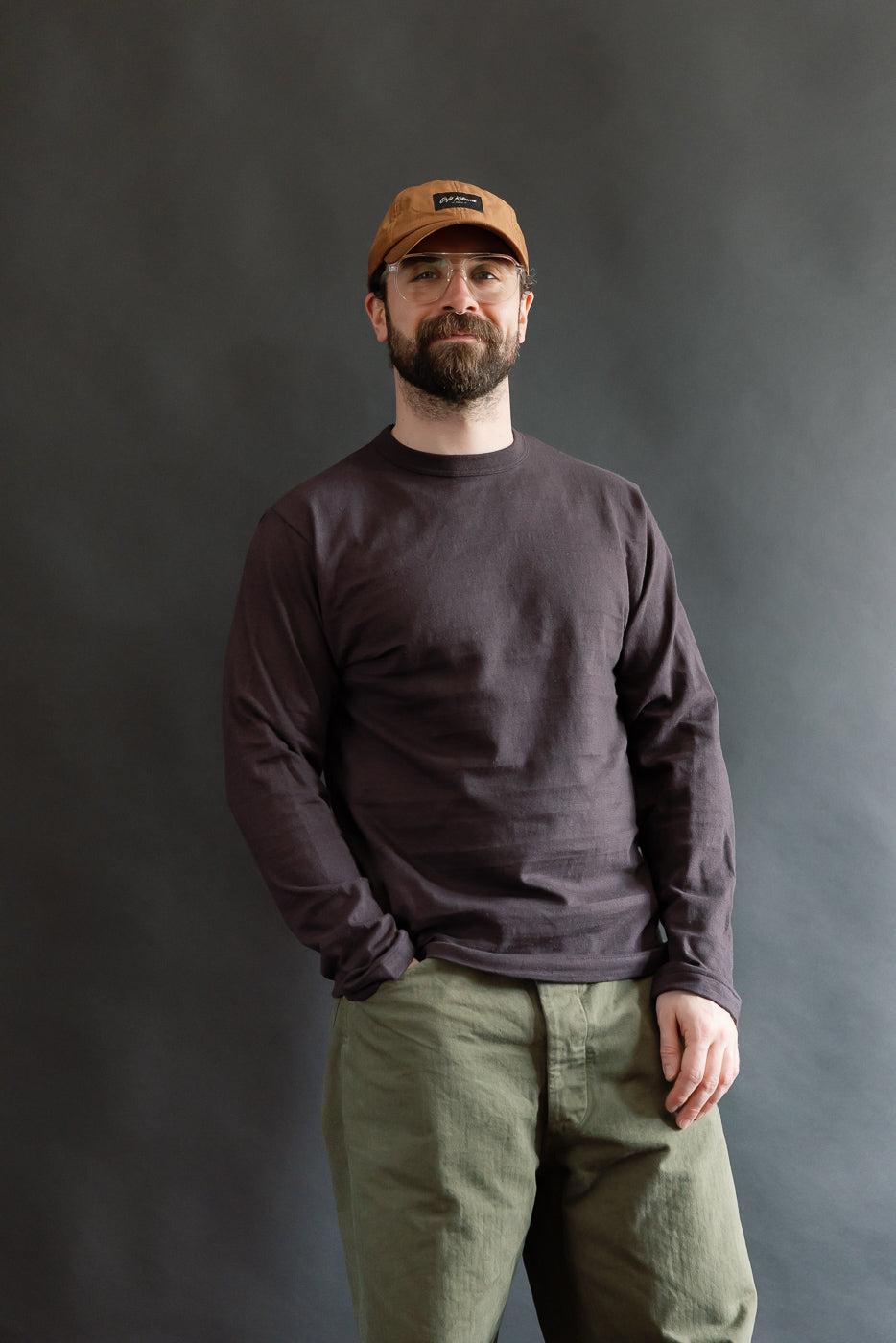 Male model 5'9, 165lbs, athletic build wearing Warehouse & Co. slubby cotton long sleeve t-shirt in sumi, front full body view, at Dant contemporary casual apparel.