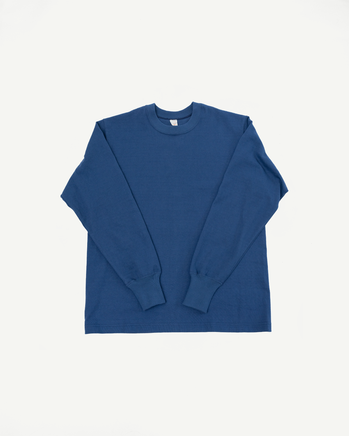 Front view flat lay of a blue long-sleeve crewneck t-shirt.