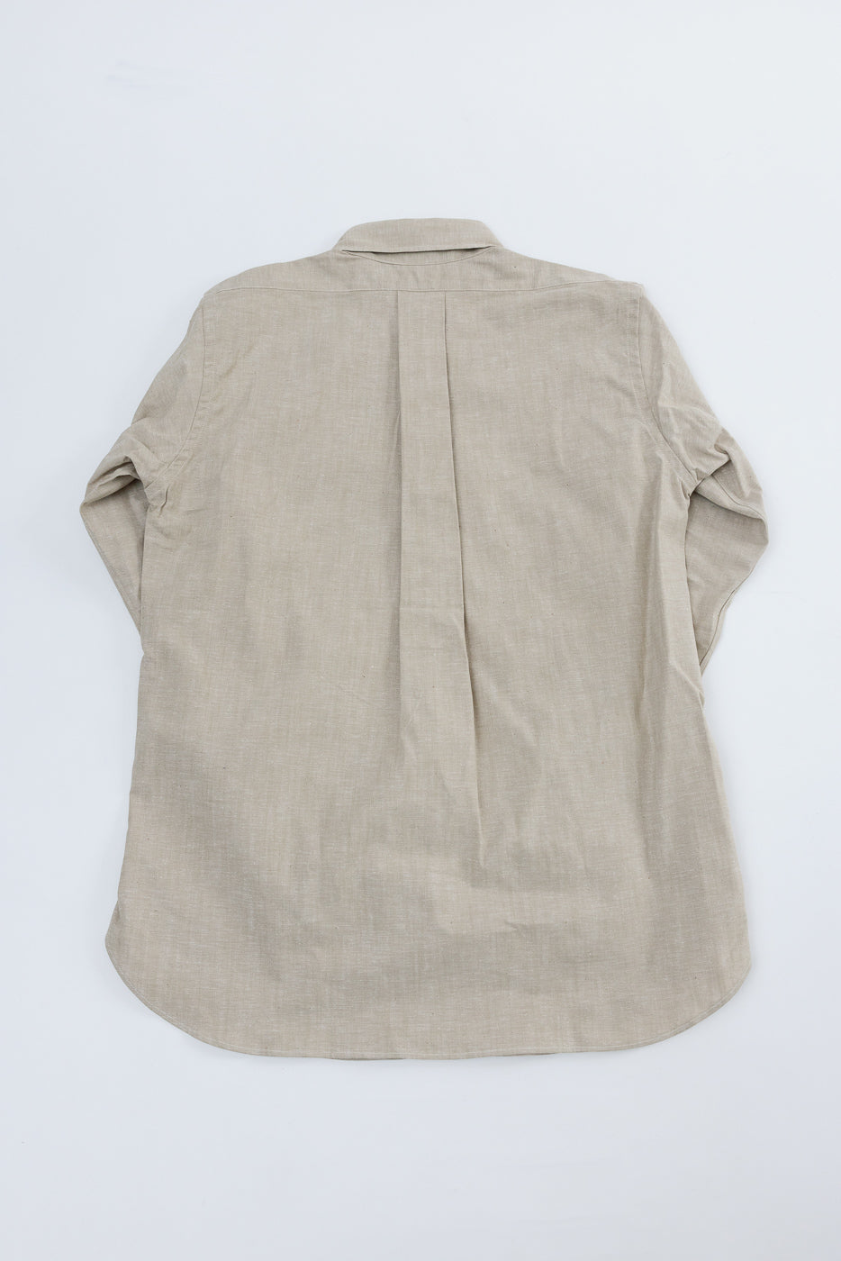 Flat lay of men's oxford shirt in brown showing full back, round collar, pleat detail, long sleeves.