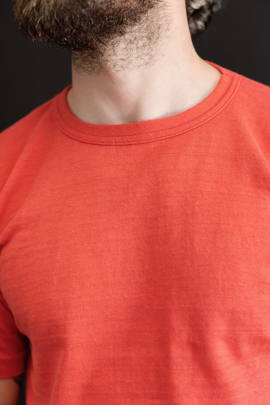 Close-up front view of a red t-shirt collar on a 5'9