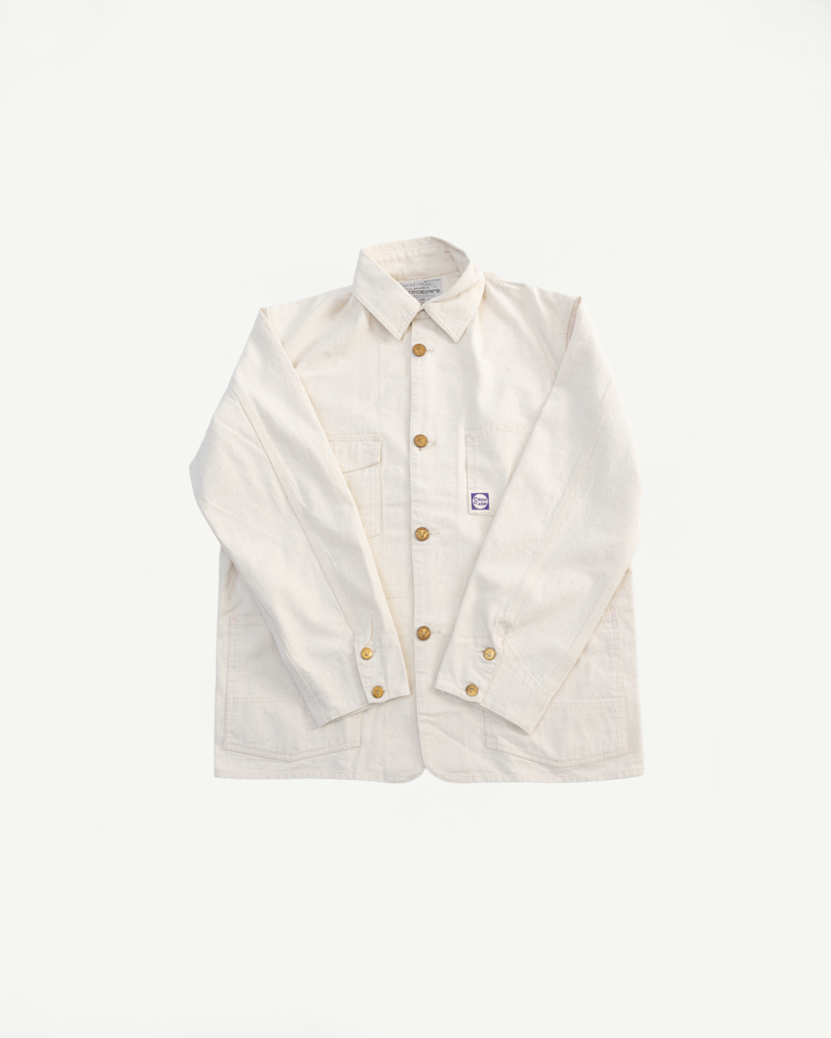 Front flat lay of ecru house painter’s jacket, button-up, textured cotton, chest pocket detail