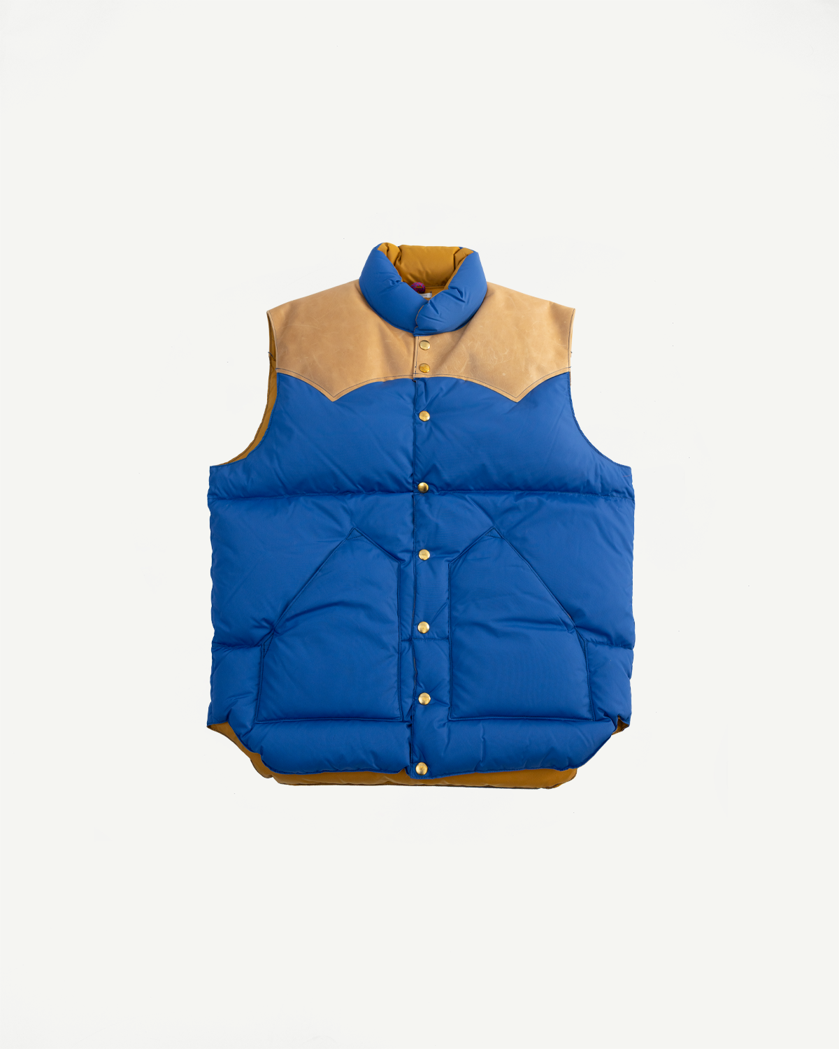 Front view flat lay of blue nylon down vest with tan yoke, snap buttons, and high collar