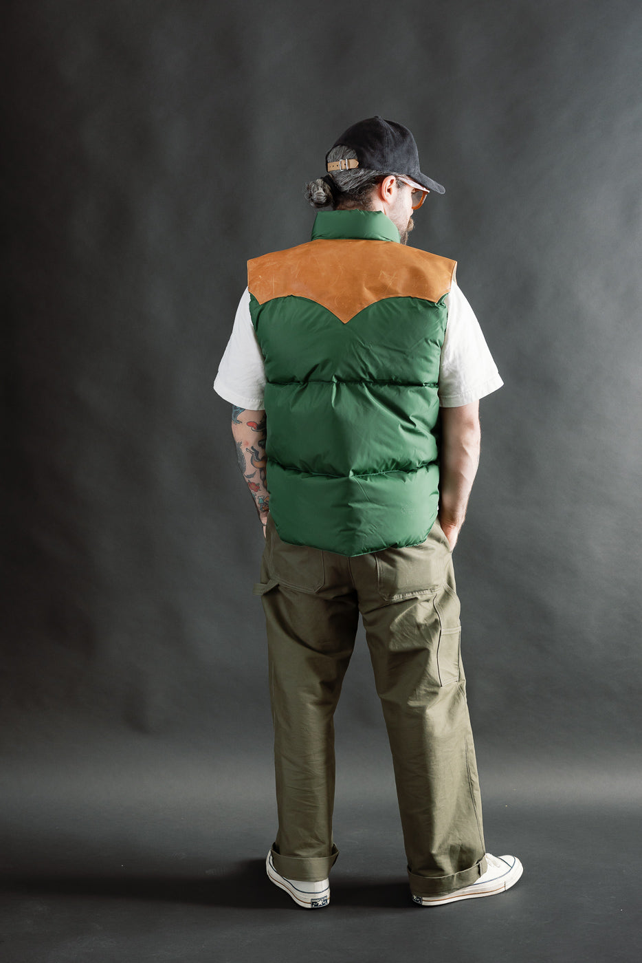 Male model 5'9 165lbs wearing bottle green nylon down vest, back view, full body