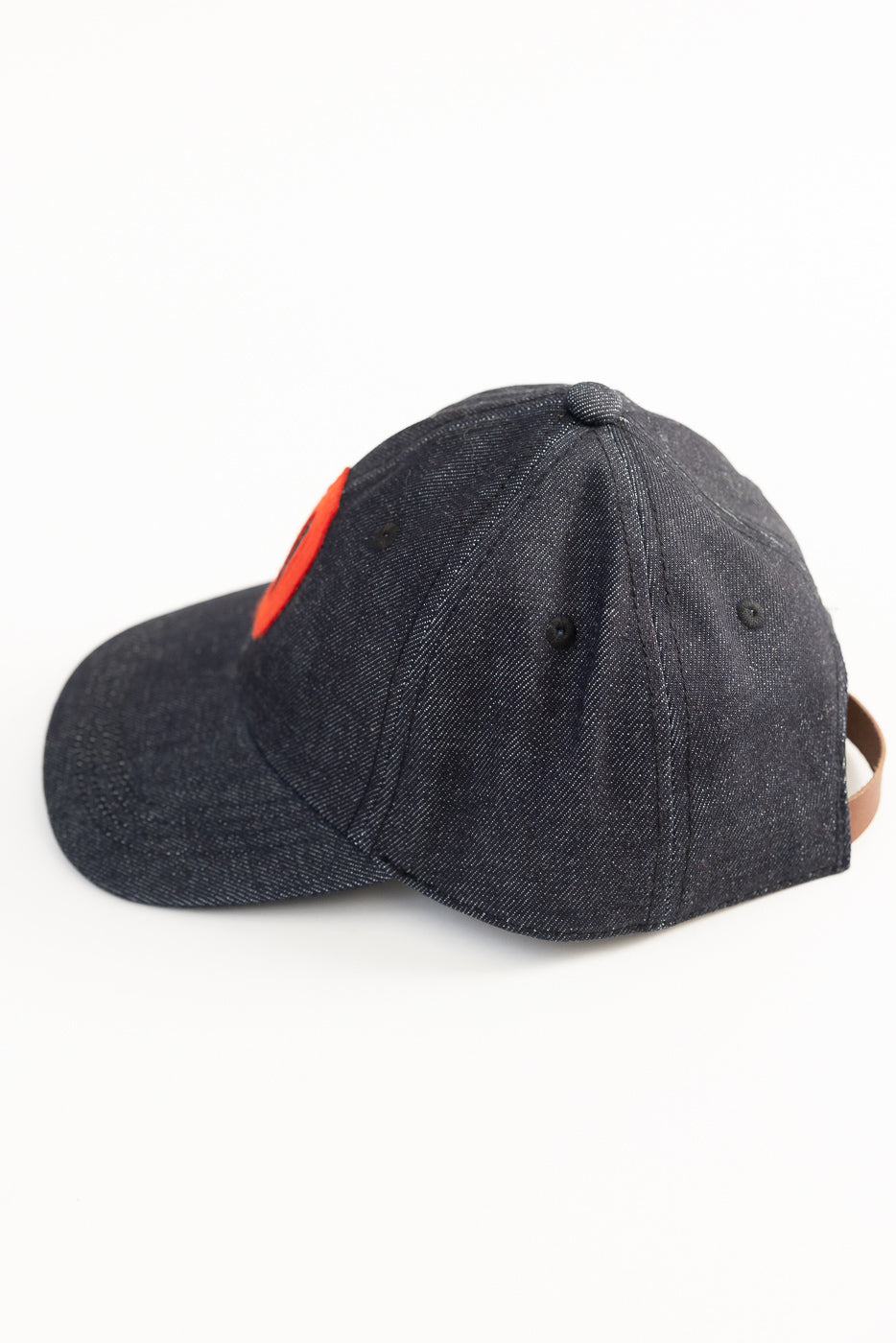 Close-up right side of Warehouse Lot 303 Strong Denime indigo baseball cap, showing denim fabric texture and partial leather strap.