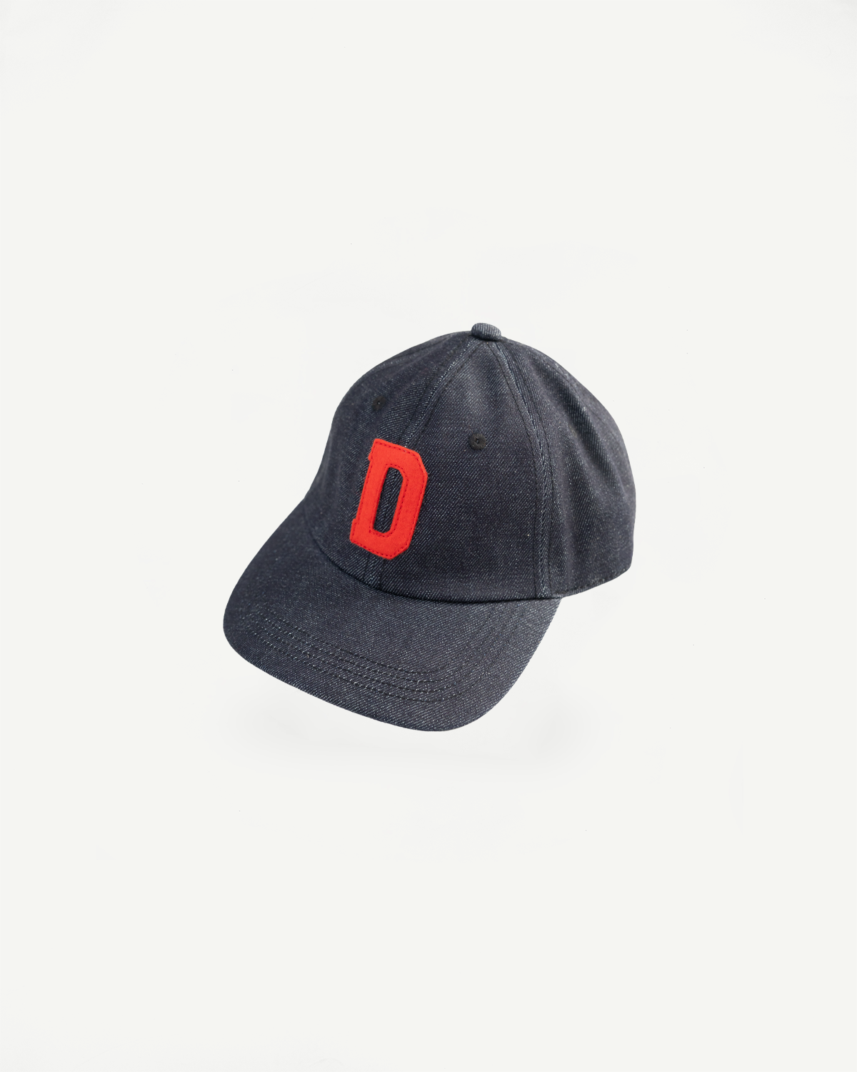 Front view close-up of Warehouse Lot 303 Strong Denime indigo baseball cap with red D patch, flat lay.
