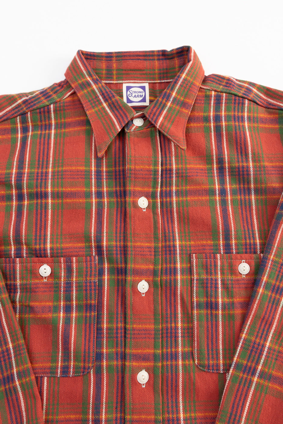 Close-up of front chest and collar on red plaid 1940s-style storm shirt, shows button details.