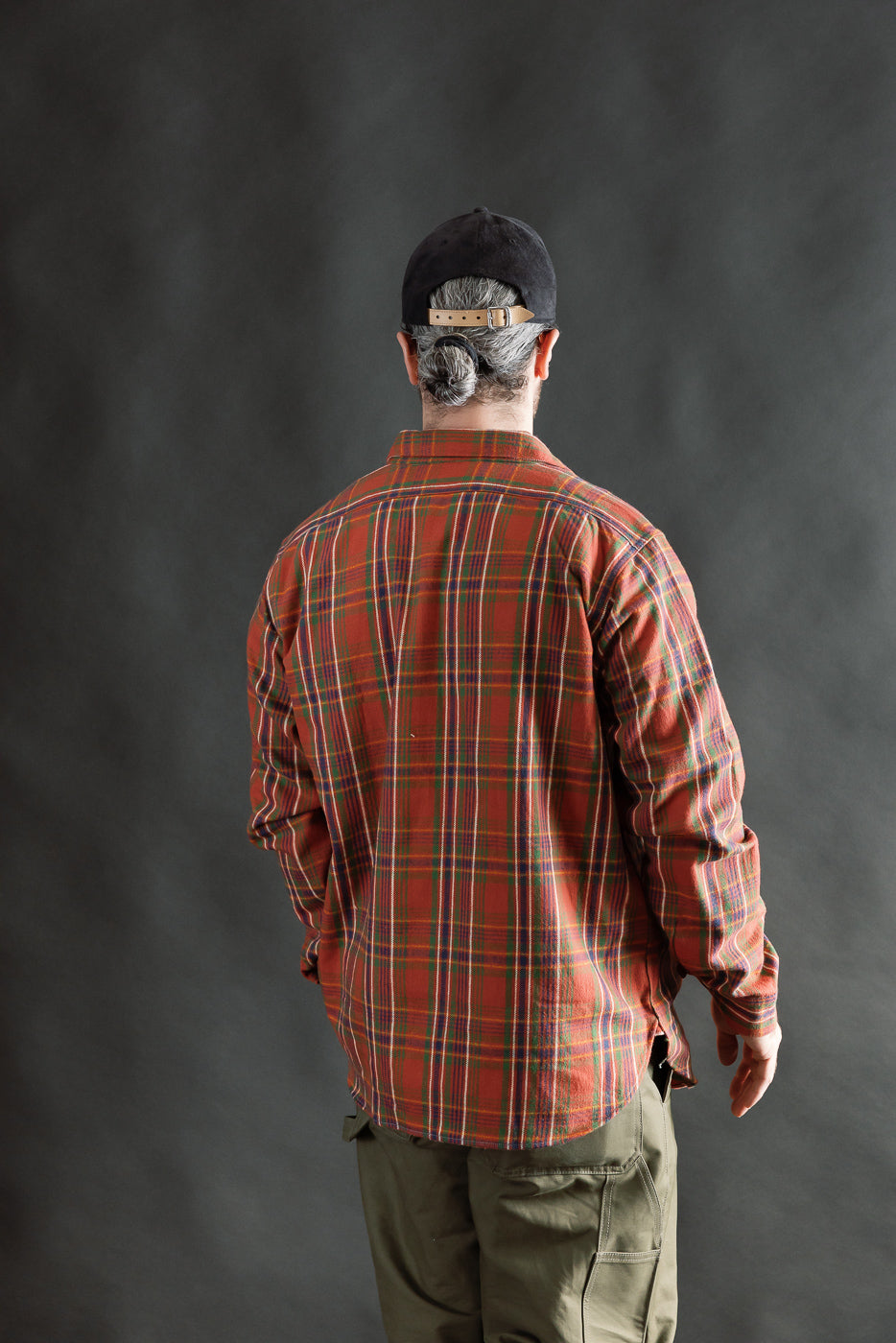 Back view of red plaid storm shirt on male model, 5'9