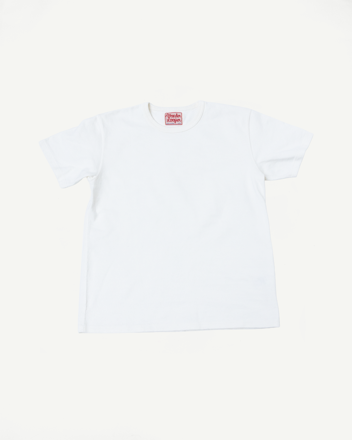 Front view flat lay of a white short-sleeve t-shirt with a red neck tag.