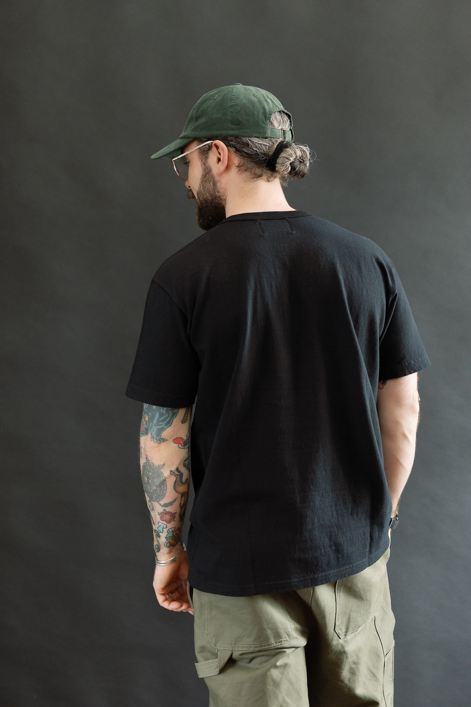 Man in an ELS Recycled Cotton Slub Crewneck T-Shirt - Black, with an athletic fit. The shirt's texture and craftsmanship reflect Dant's focus on premium, Japanese-made menswear.