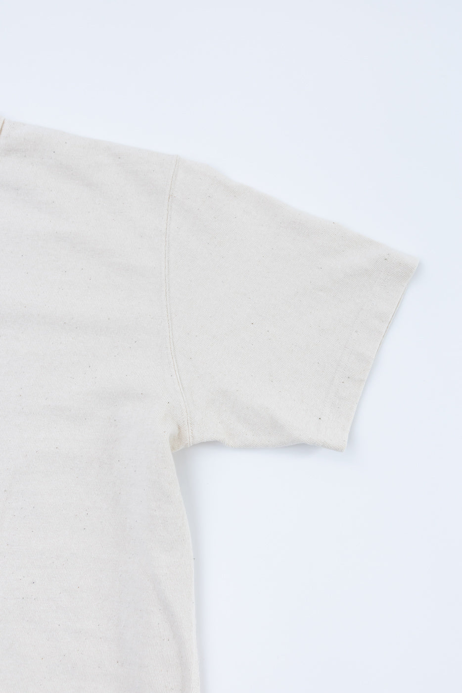 ELS Recycled Cotton Slub Crewneck T-Shirt - Ecru, showcasing the upper back and right sleeve. The off-white cotton fabric appears soft and textured, embodying the artisanal craftsmanship typical of Dant's curated collection.