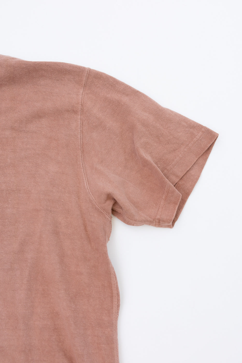 Close-up front view of dusty rose short-sleeve tee, showing ribbed texture and clean hem detail