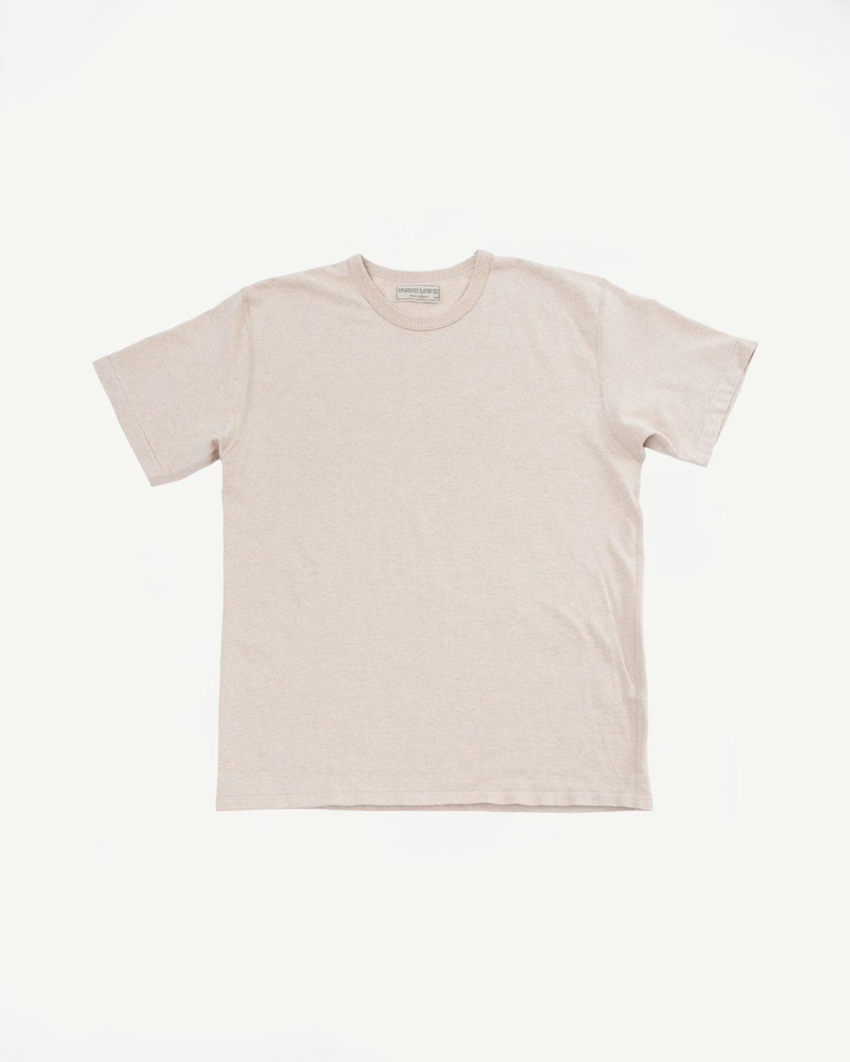 Beige crew neck t-shirt flat lay, front view, showing tag detail and soft cotton texture