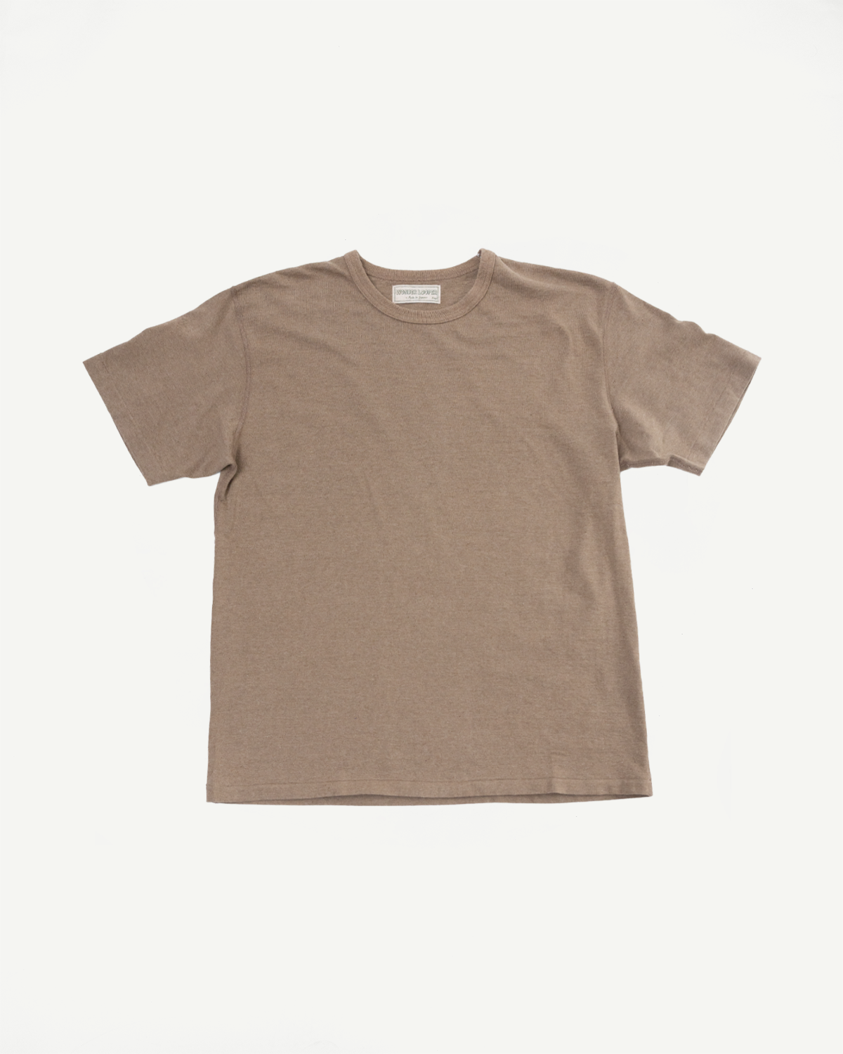 Front view of a beige crew neck t-shirt with tag detail, flat lay