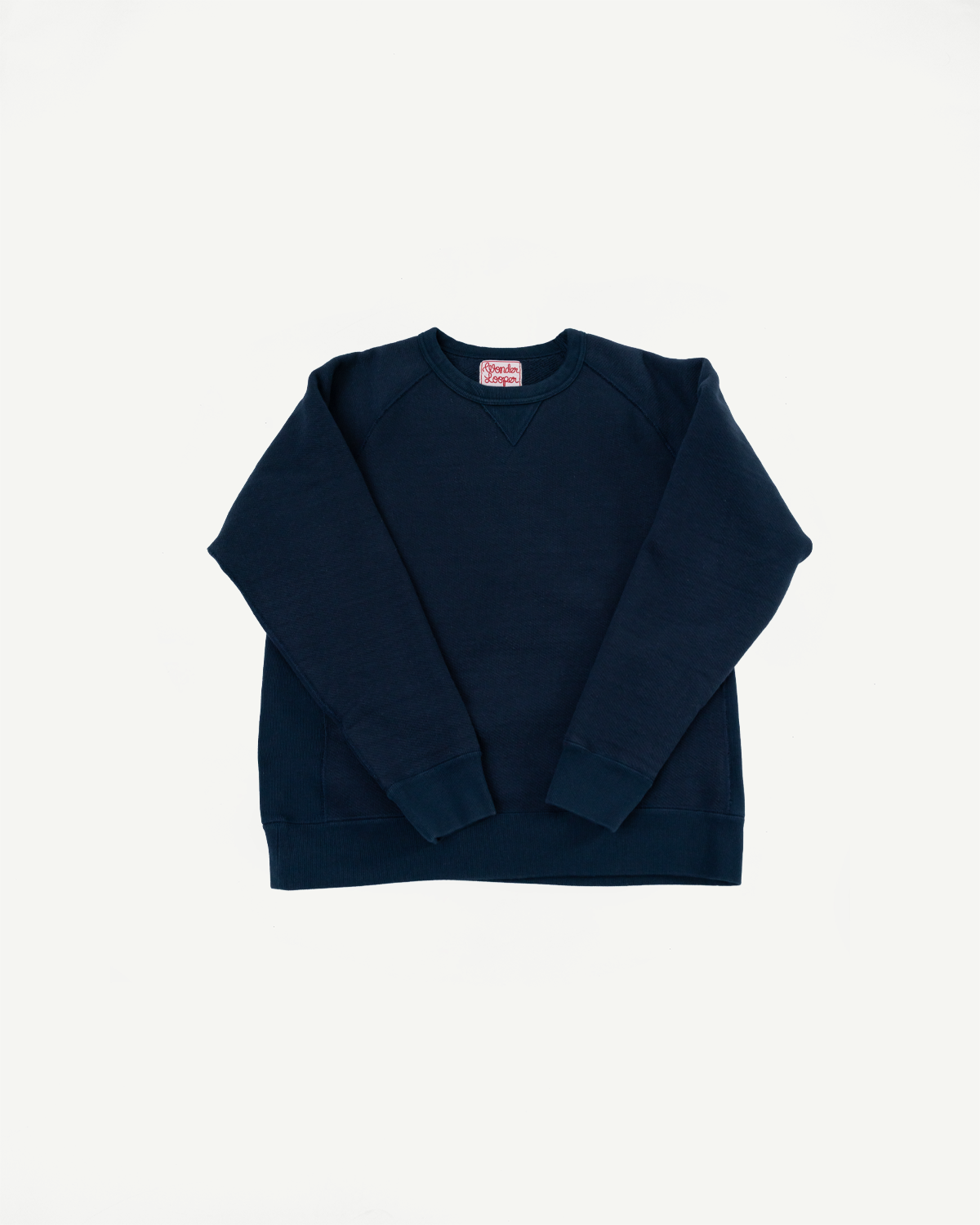 Front view flat lay of a navy blue crewneck sweatshirt with ribbed cuffs and hem.