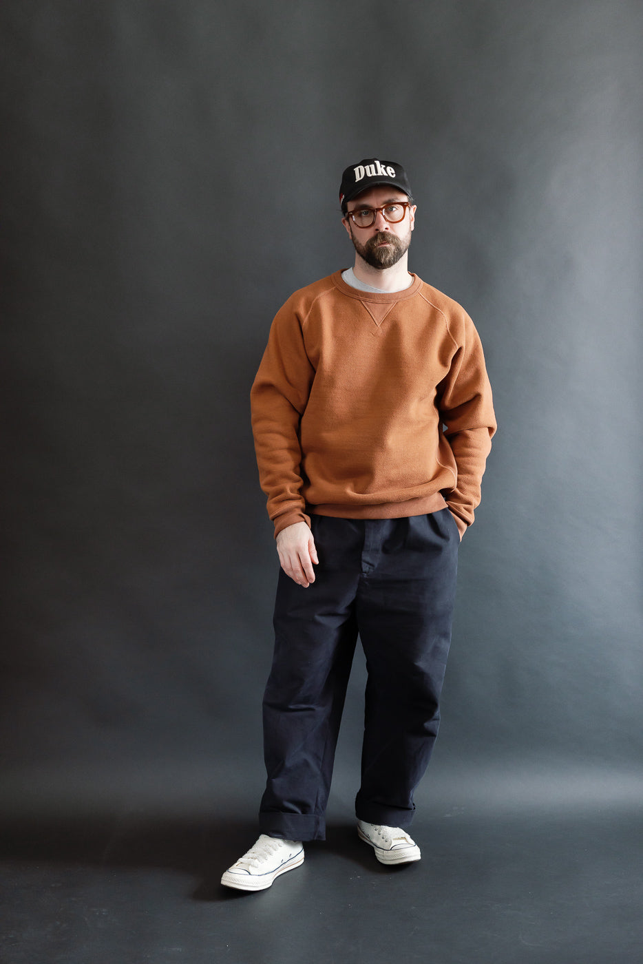 Male model 5'9, 165lbs athletic build wearing rust French terry pullover crewneck, front full body