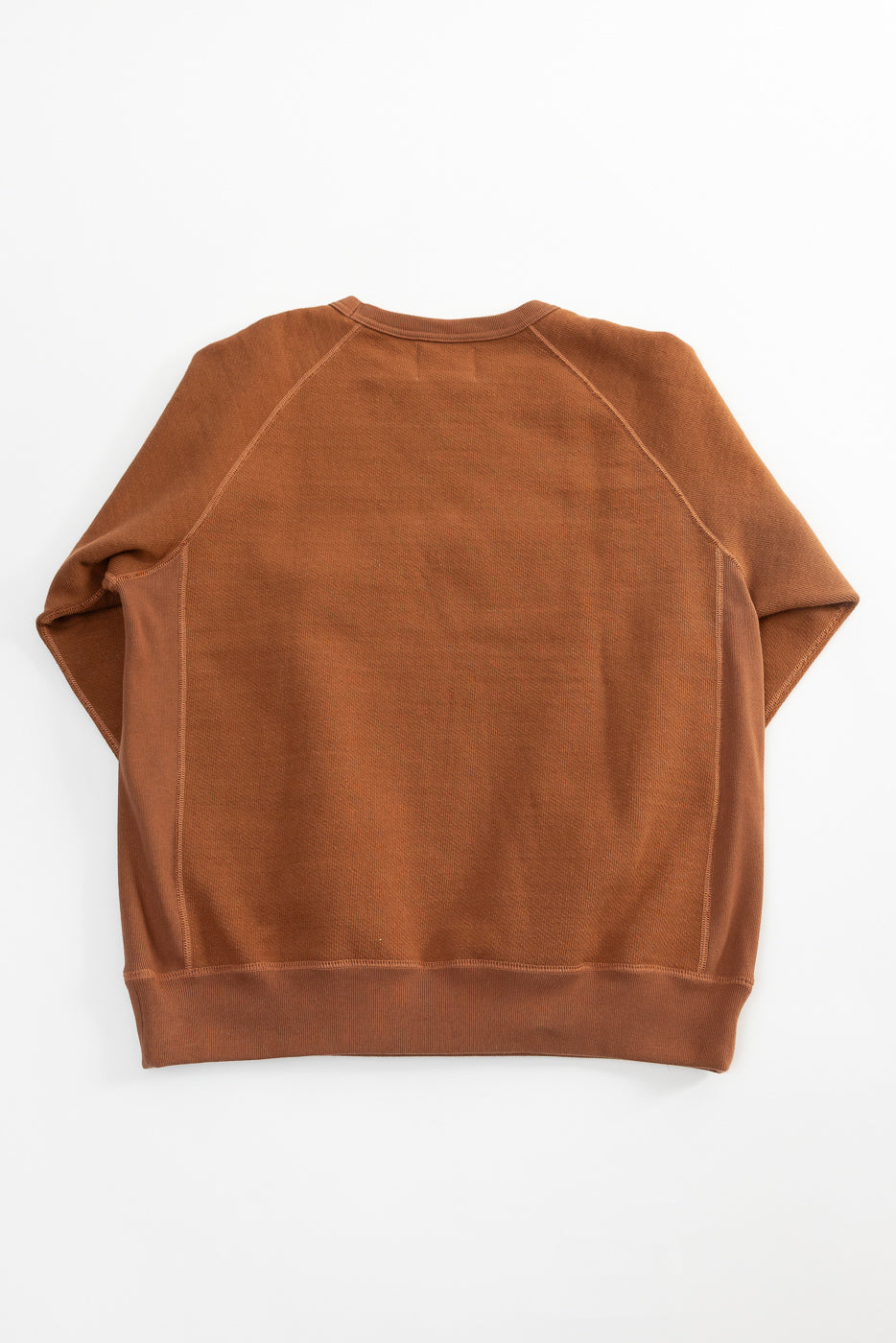 Flat lay of rust Wonder Looper pullover crewneck, back view, double heavyweight French terry
