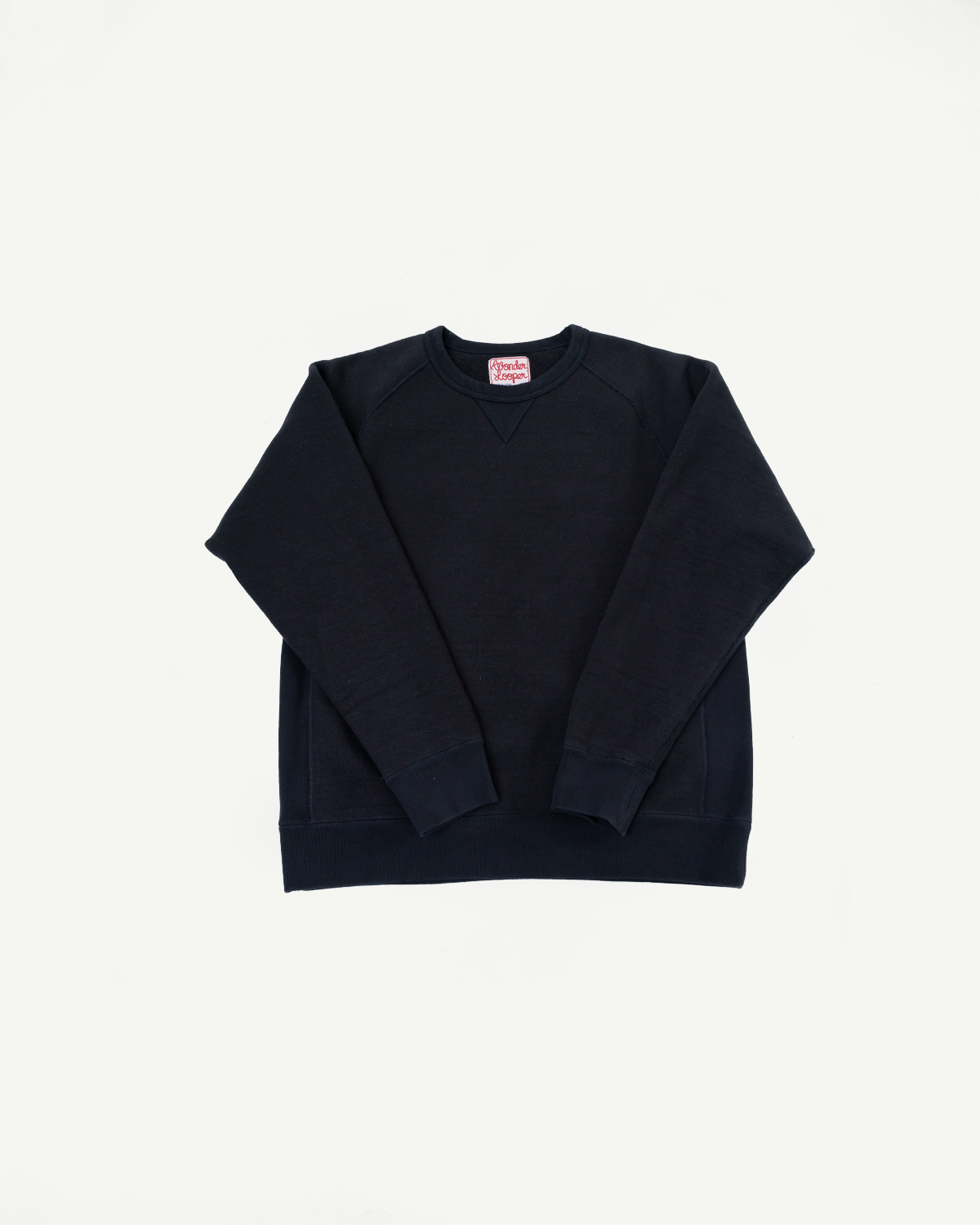 Flat lay, front view of a navy blue crewneck sweatshirt with ribbed cuffs and hem.