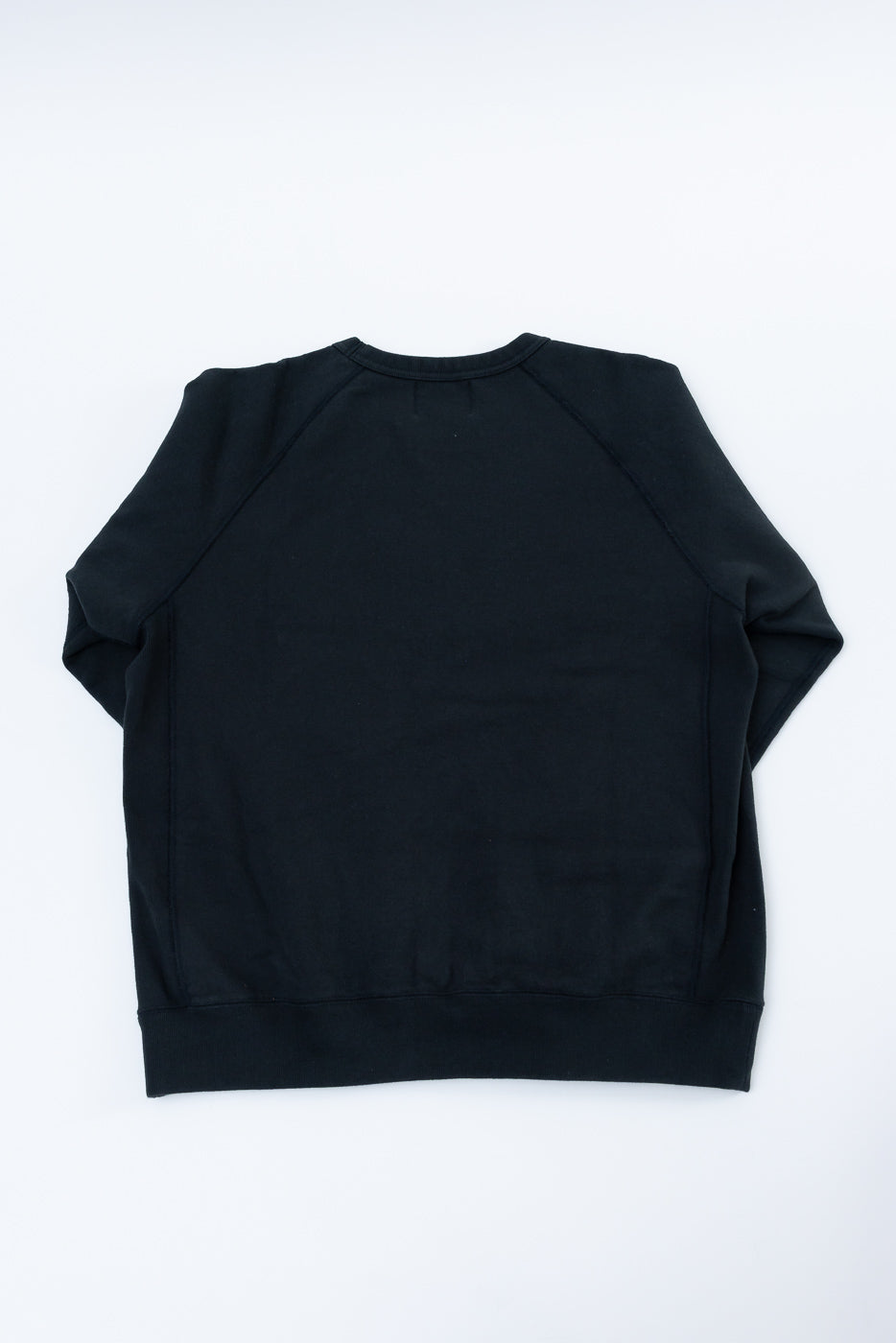 Pullover Crewneck - Super Looper French Terry - Sumi, back view laid flat, showcasing premium textured loop fabric, raglan sleeves, and ribbed side panels, highlighting meticulous Japanese craftsmanship and modern athletic fit.