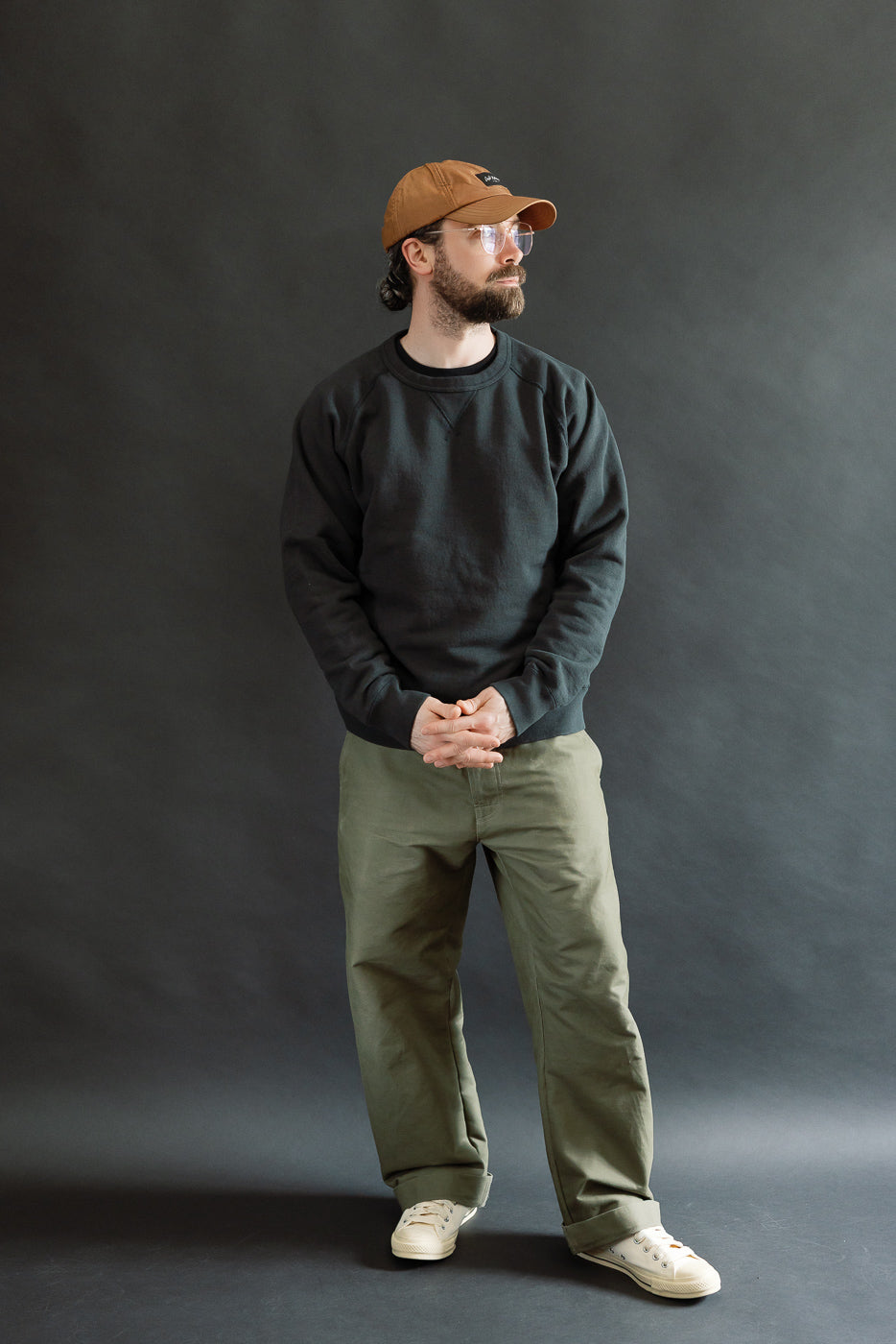 Pullover Crewneck - Super Looper French Terry - Sumi showcased on a 5'9 male model, styled with olive-green pants. The crewneck features a textured Japanese terry fabric with raglan sleeves and ribbed detailing.