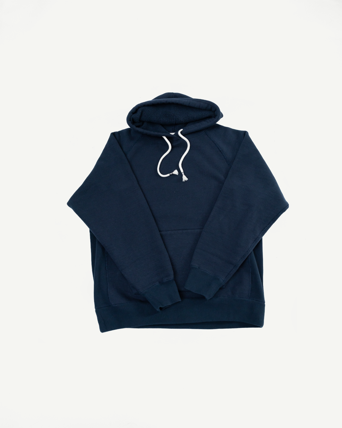Flat lay front view of a navy blue hooded sweatshirt with white drawstrings.
