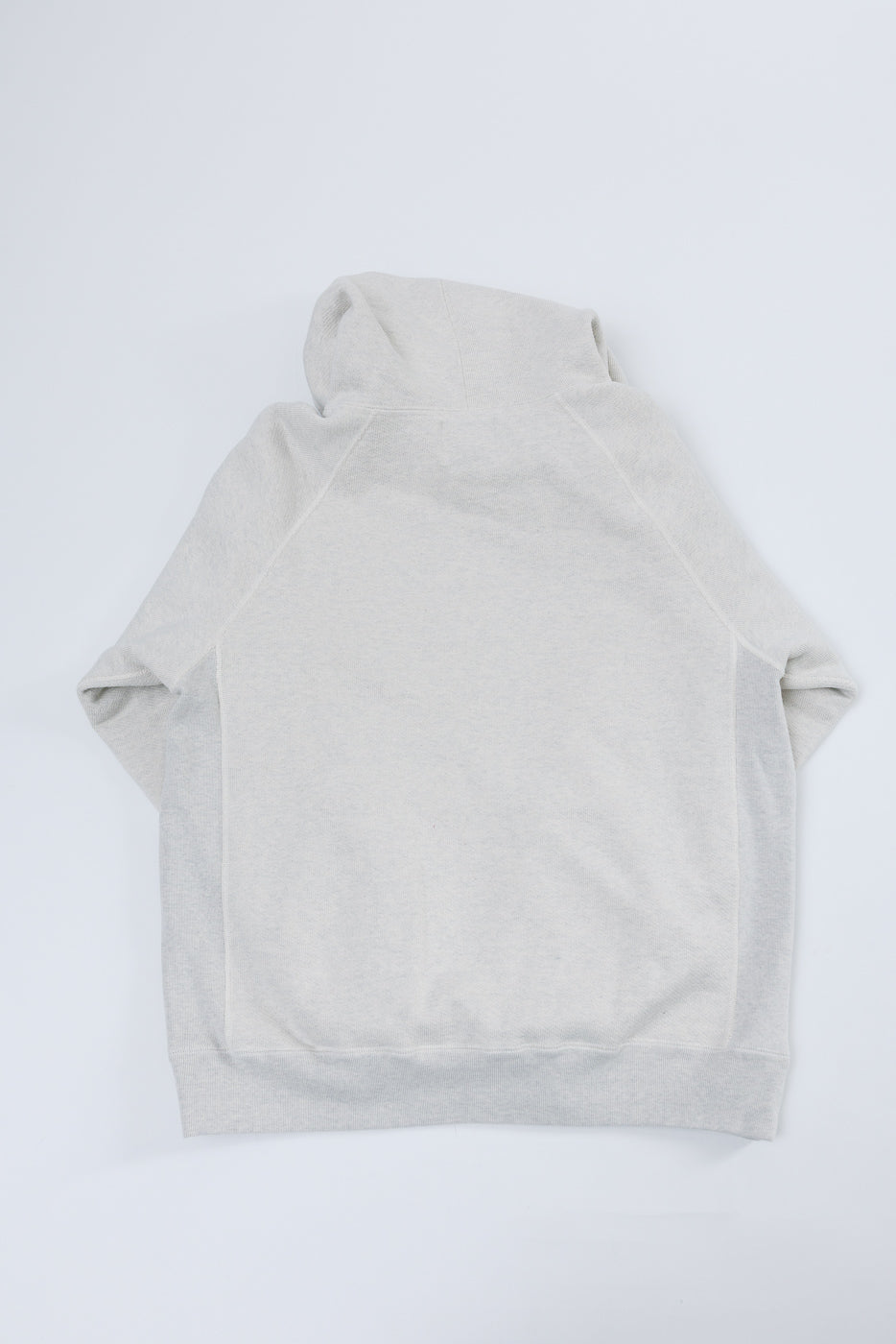 Flat lay, back view of a light grey hooded sweatshirt showing the hood and hem.