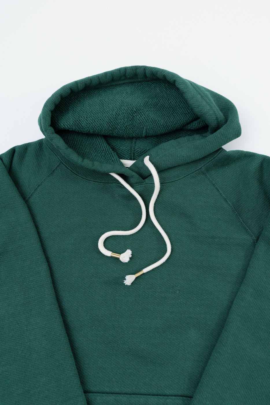 Front view flat lay of a dark green hooded sweatshirt with white drawstrings.
