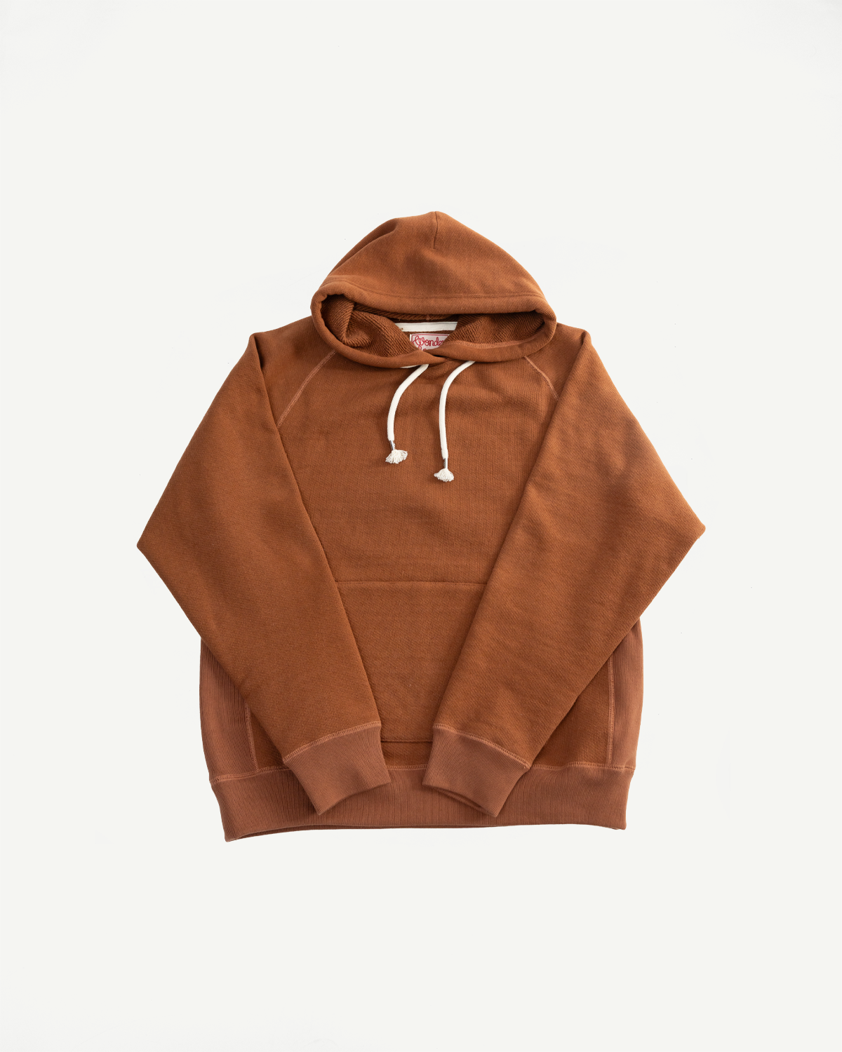Front flat lay of Wonder Looper rust pullover hoodie, double heavyweight French terry, showing hood, drawstrings, ribbed cuffs, and hem.