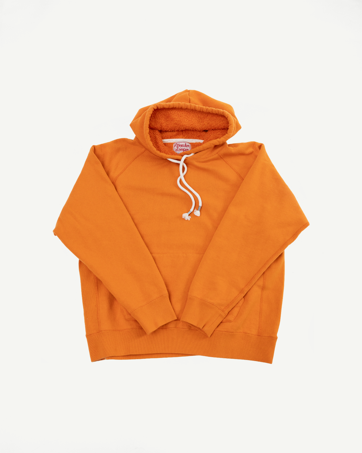 Pullover Hoodie - Super Looper French Terry - Orange: Bright orange hoodie with sherpa-lined hood, white drawstrings, raglan sleeves, kangaroo pocket, and ribbed cuffs and hem, showcasing unique Japanese loopback fabric texture.