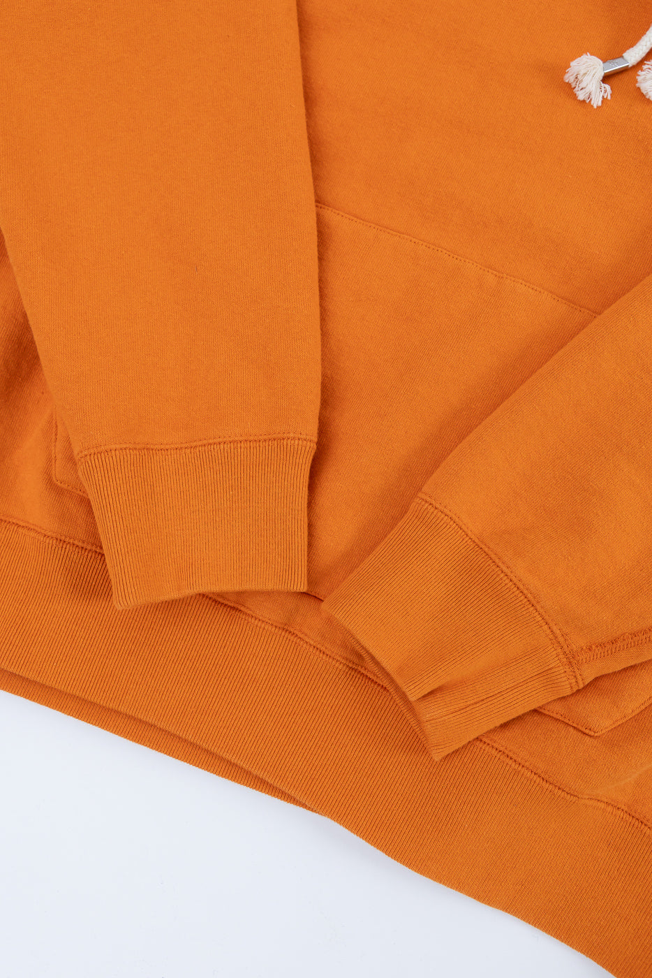 Pullover Hoodie - Super Looper French Terry - Orange, showcasing ribbed cuffs, hem, kangaroo pocket, and drawcord tip. Fabric’s textured interior and smooth exterior reflect Dant's premium craftsmanship in Japanese apparel.