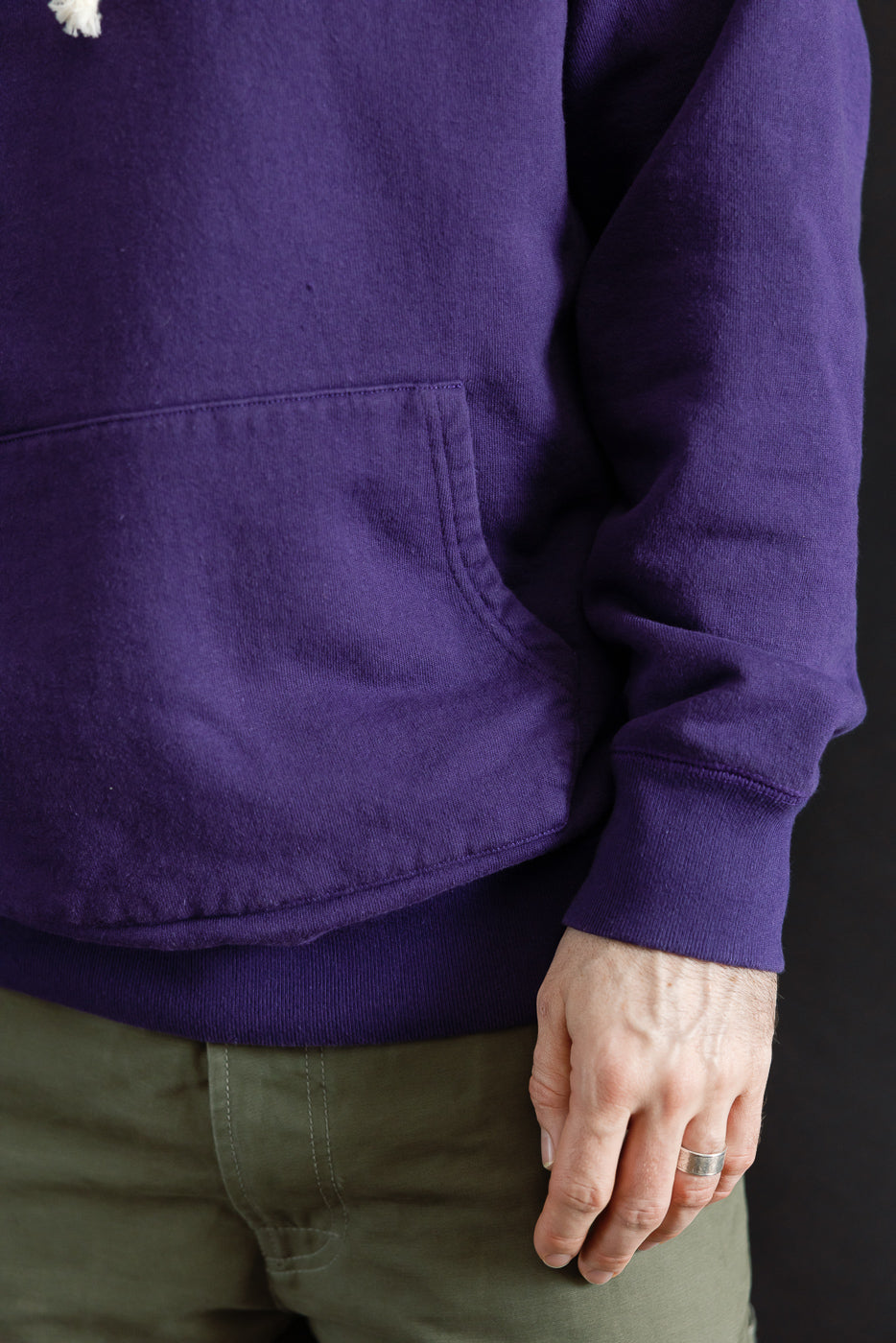 Pullover Hoodie - Super Looper French Terry - Purple, featuring a textured loopback fabric, kangaroo pocket, and flat seam construction, worn over olive-green pants, showcasing premium craftsmanship from Dant's curated collection.