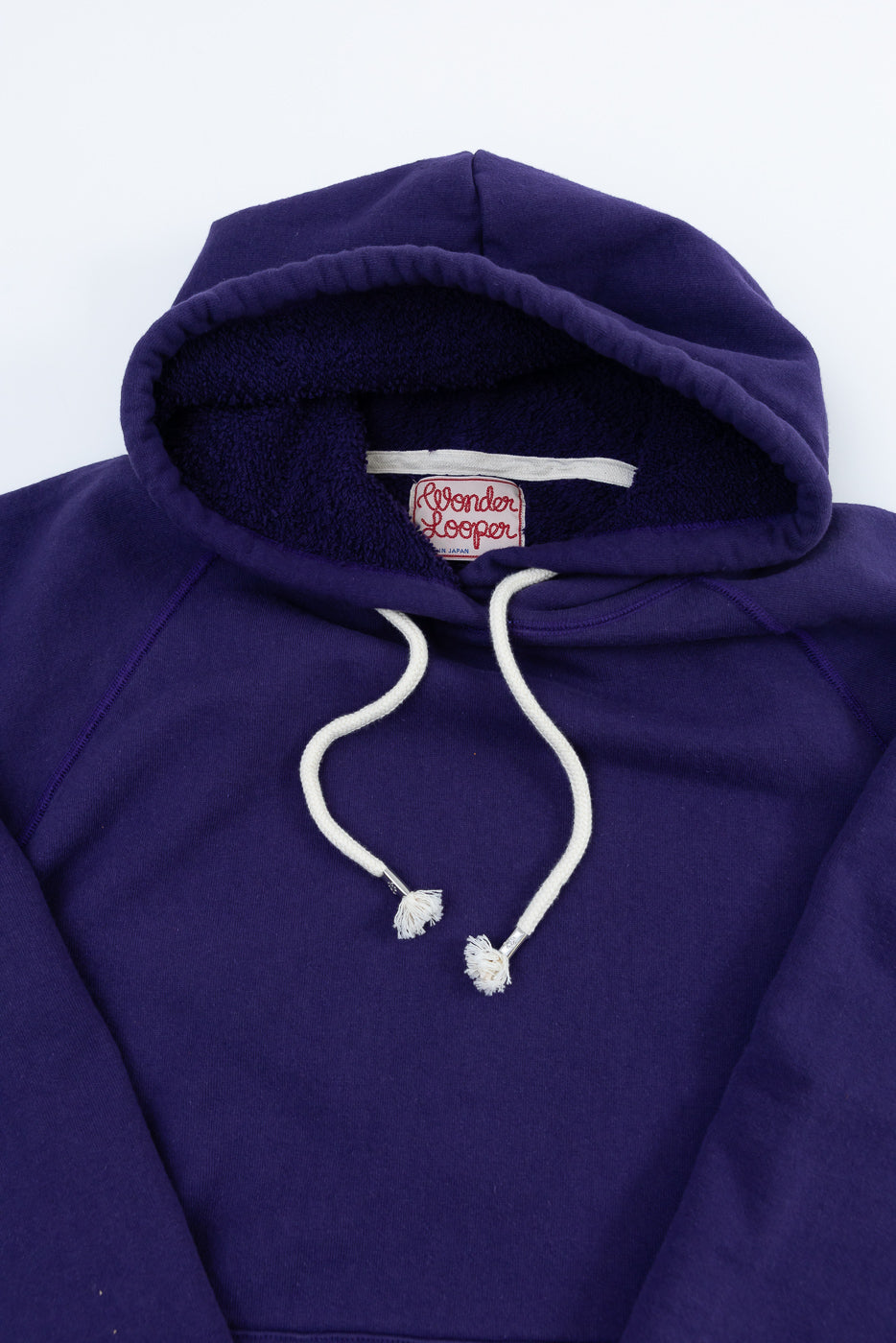 Pullover Hoodie - Super Looper French Terry - Purple features a deep purple hue, fluffy terry-lined hood, and distinct white rope drawstrings, embodying a refined, textured design from Japanese Tsuriami knit fabric.