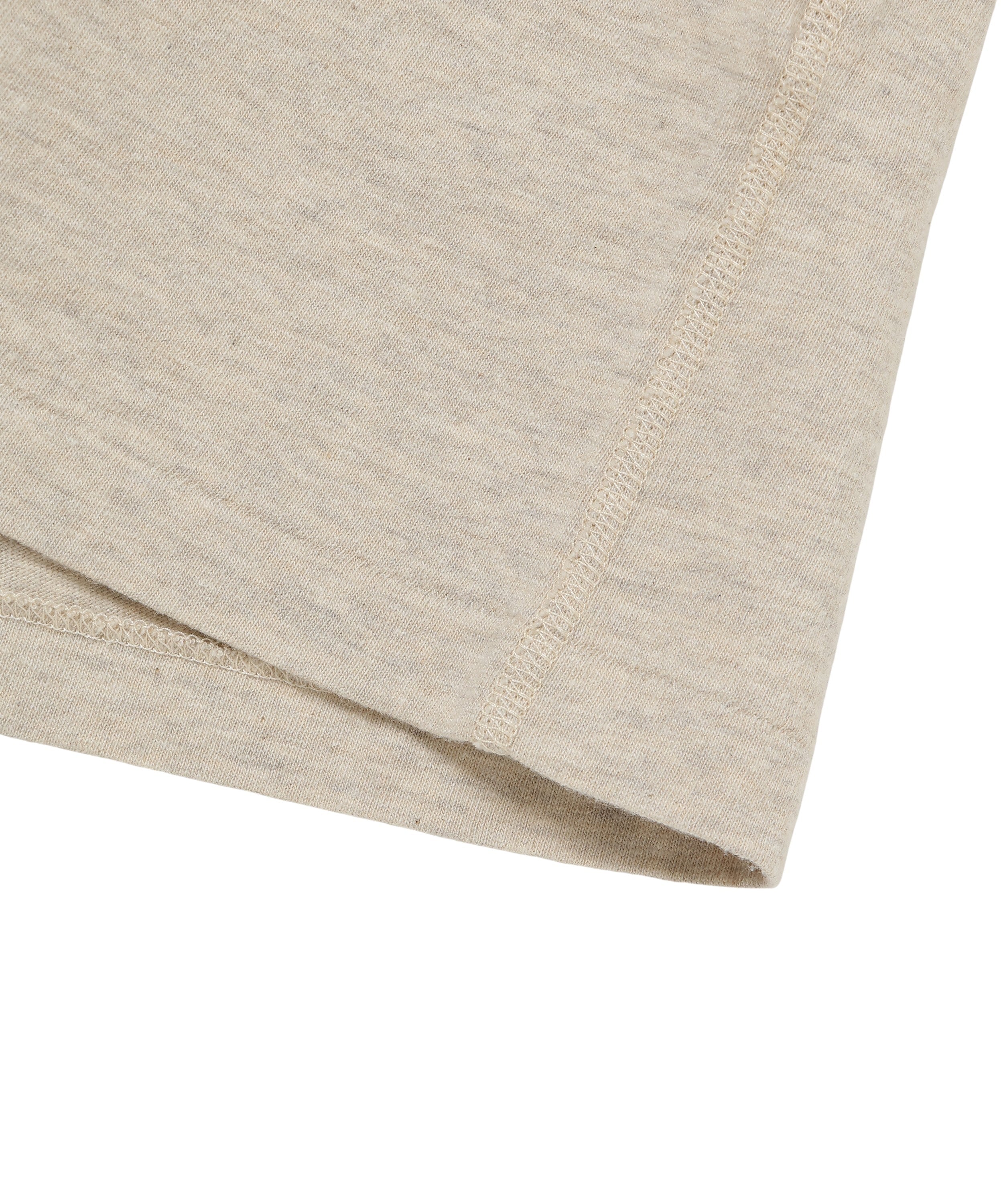 Close-up of recycled cotton ringer T-shirt stone color, showing hem stitching and fabric texture.